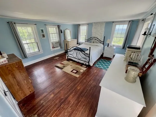 a bedroom with furniture and a window
