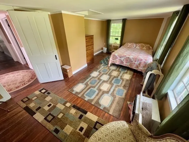 a bedroom with furniture and a window