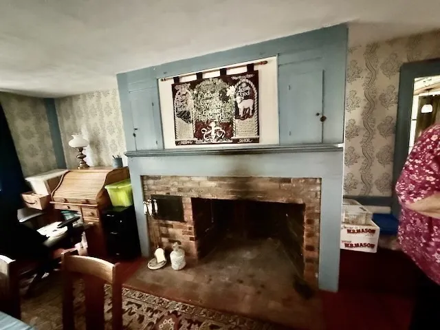 a living room with furniture a fireplace and a large window