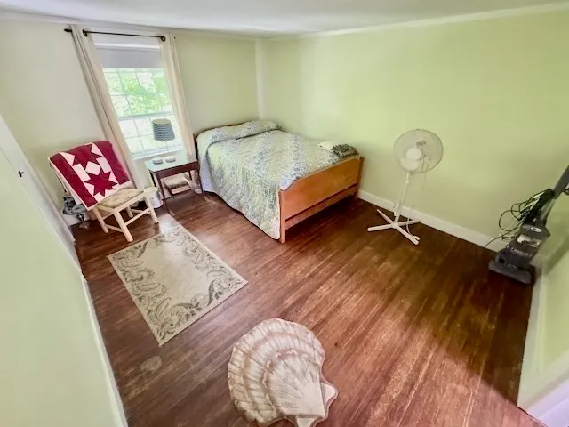 a bedroom with a bed window and a table