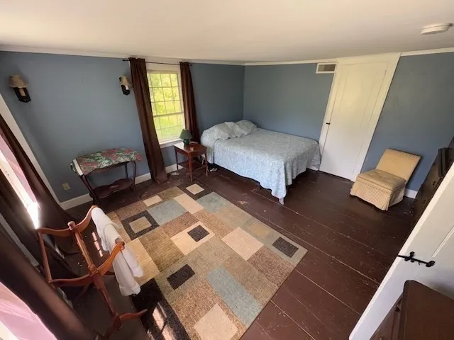 a bedroom with a bed and a mirror