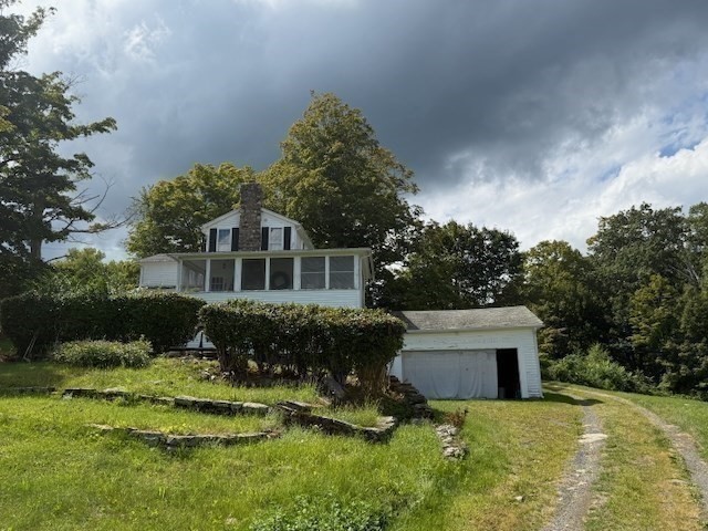604 Main Road Granville, MA 01034 - Photo 21 of 36 a front view of a house with a yard