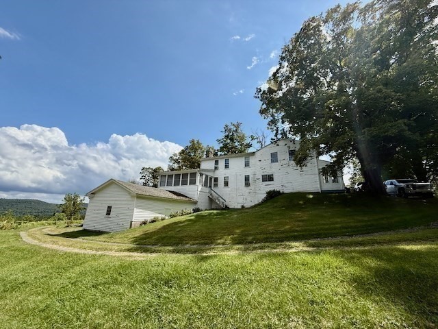 604 Main Road Granville, MA 01034 - Photo 26 of 36 a view of a big house with a big yard and large trees