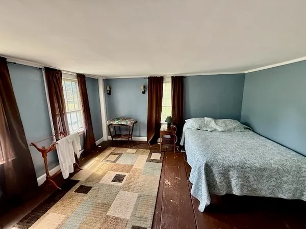 a bedroom with a large bed and a rug