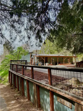 a view of a balcony with wooden floor and fence
