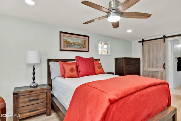 a bed room with a bed and a lamp