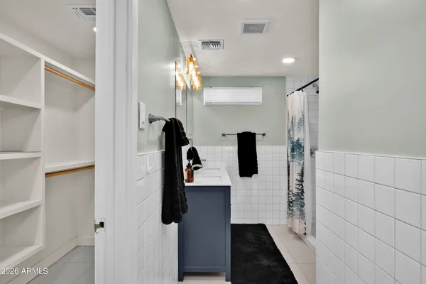 a bathroom with a shower and mirror