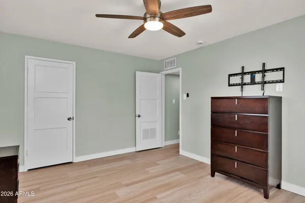 a room with a dresser and a chandelier