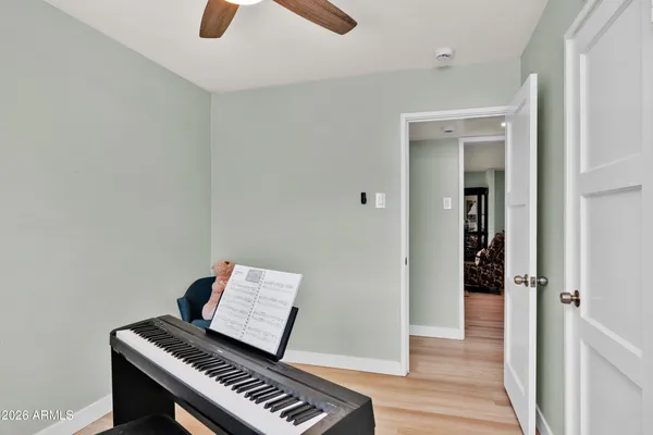 a view of an empty room with wooden floor