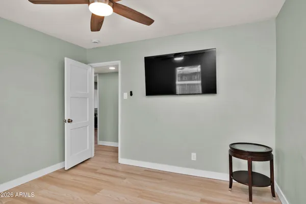 a view of a livingroom with wooden floor and workspace