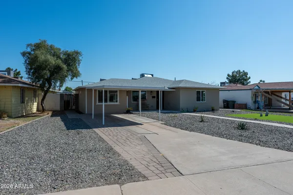 a front view of a house with a yard and a garage