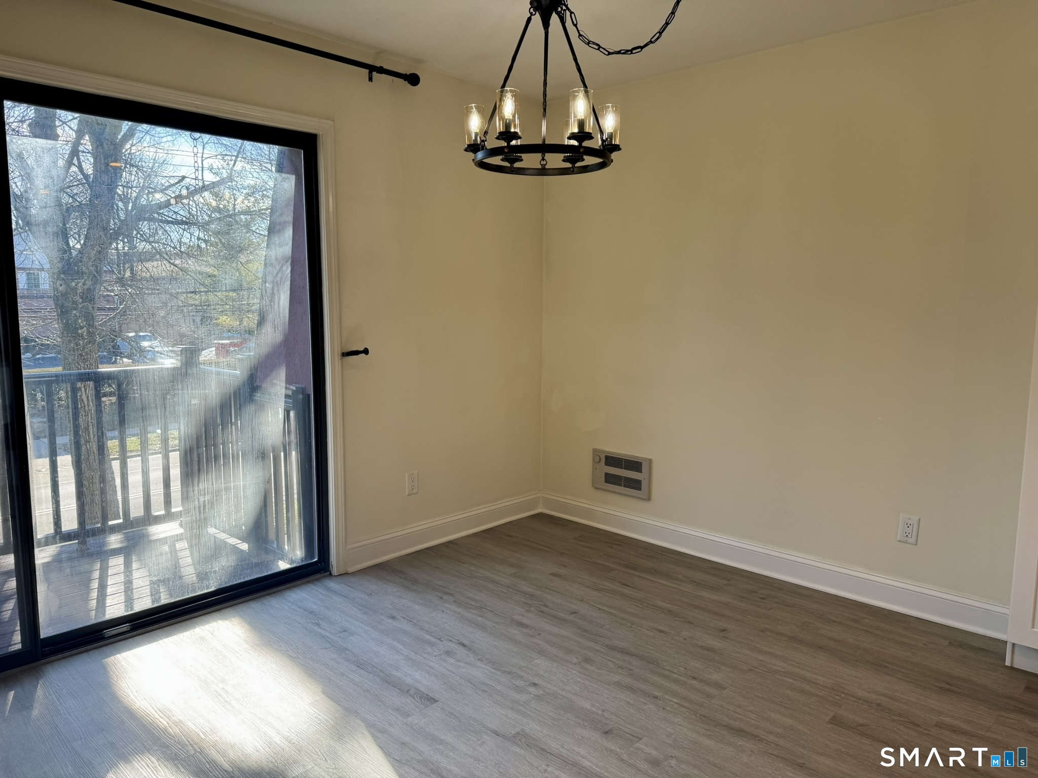 76 Maple Tree Avenue, Unit 6 Stamford, CT 06906 - Photo 12 of 27 a view of a room with wooden floor and a window