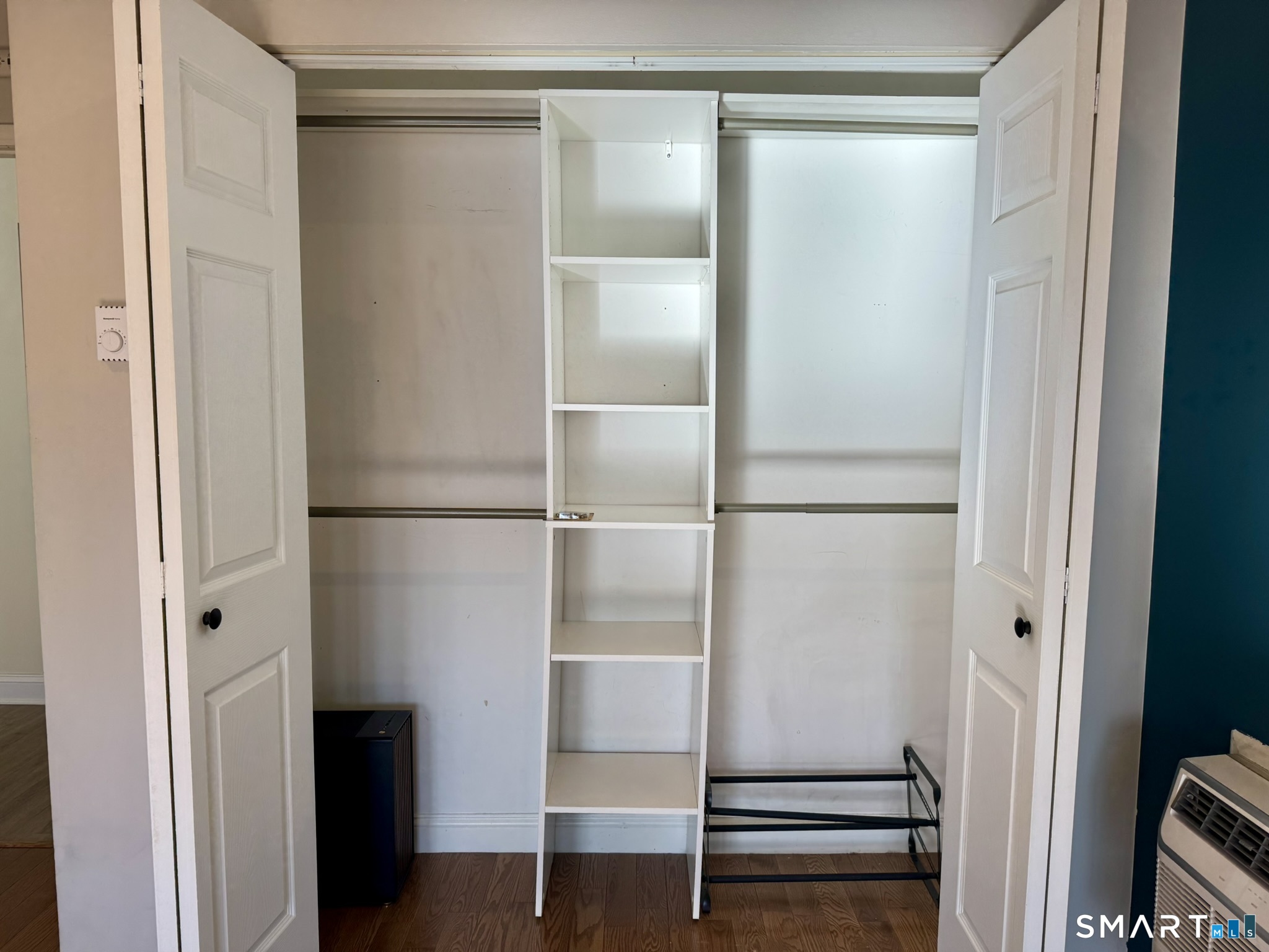 76 Maple Tree Avenue, Unit 6 Stamford, CT 06906 - Photo 16 of 27 a room with walk in closet and wooden floor