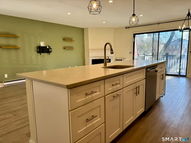 a kitchen with stainless steel appliances a refrigerator sink and microwave