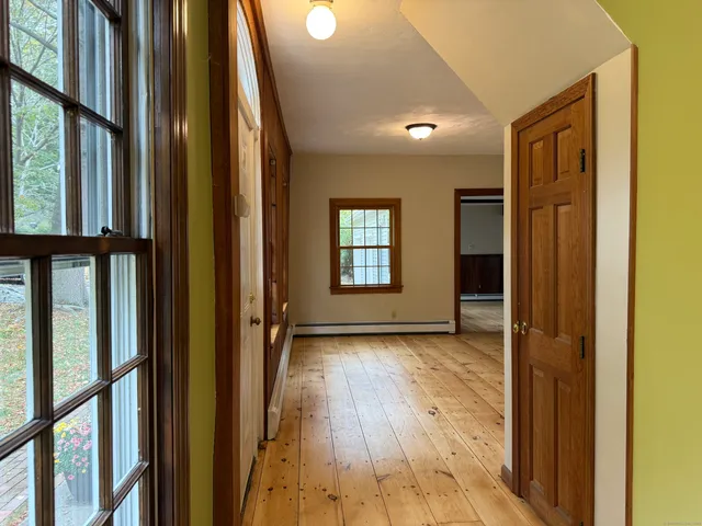 a view of hallway with wooden floor and stairs