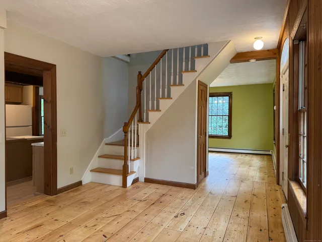 a view of entryway with wooden floor and stairs