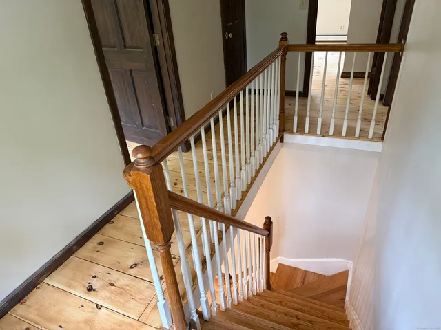 a view of staircase with wooden floor and a window