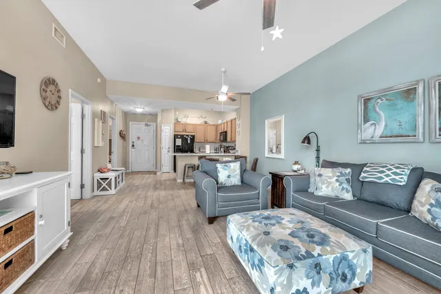 a living room with furniture and a wooden floor