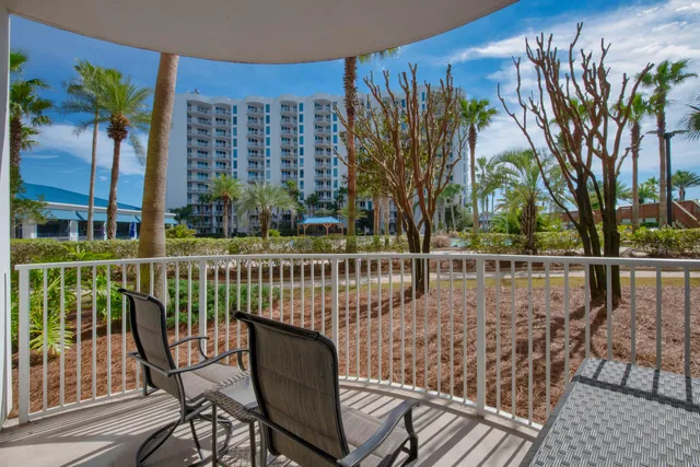 a view of balcony with wooden floor and outdoor seating