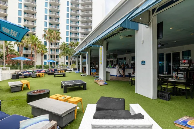 a view of a swimming pool with a yard and plants