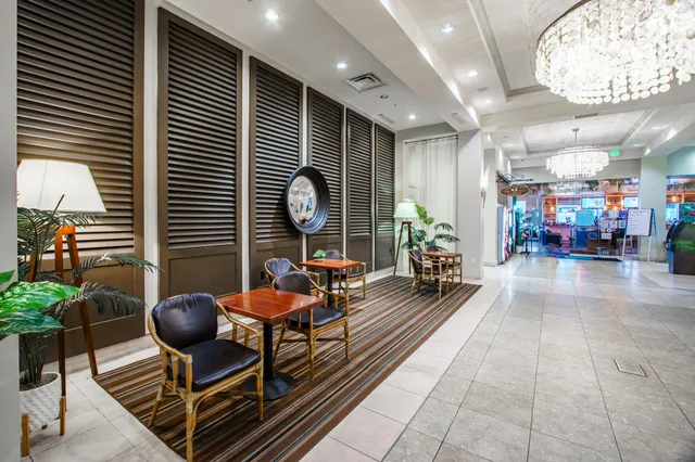 a sign that is on a wall with a palm trees