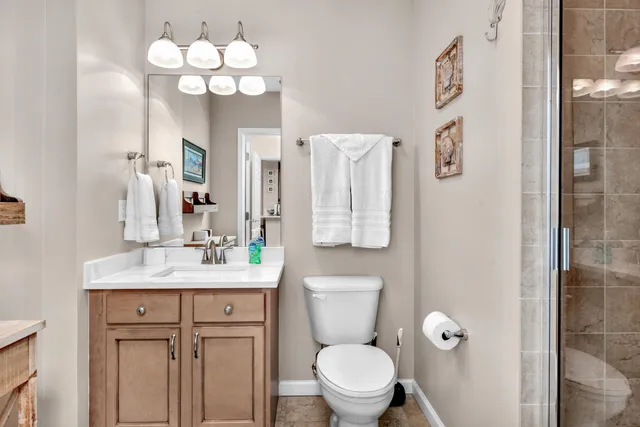 a bathroom with a toilet a sink and a mirror