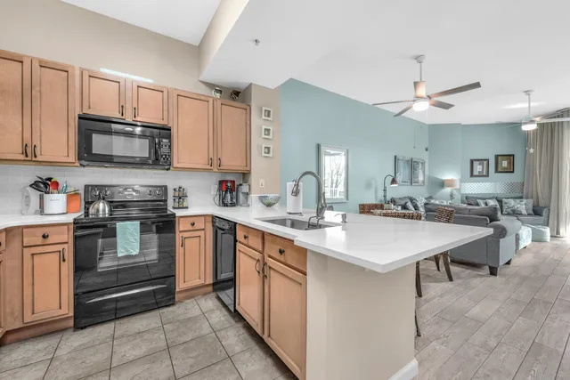 a kitchen with stainless steel appliances granite countertop a sink dishwasher stove top oven and refrigerator