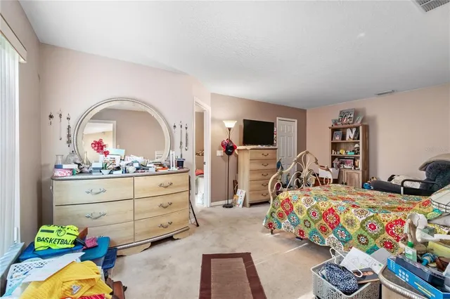 a bedroom with bed and a book shelf
