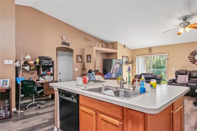 a living room with furniture a flat screen tv and a large window