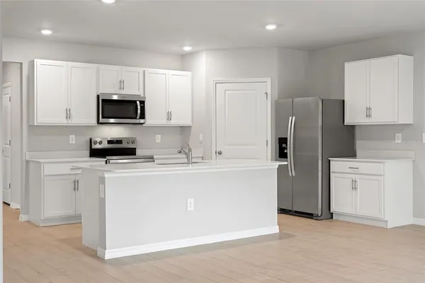 a kitchen with cabinets stainless steel appliances and a counter top space