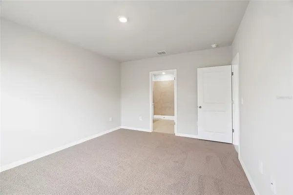 a spacious bathroom with a double vanity sink a large mirror and a shower
