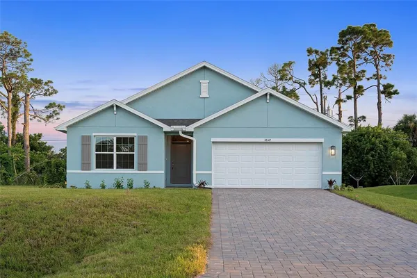 a view of a house with a yard and garage