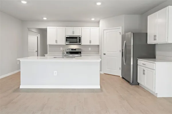 a kitchen with stainless steel appliances a refrigerator stove microwave and sink