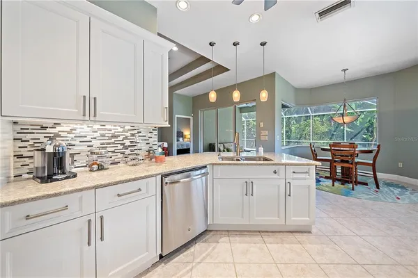 a kitchen with cabinets and chairs