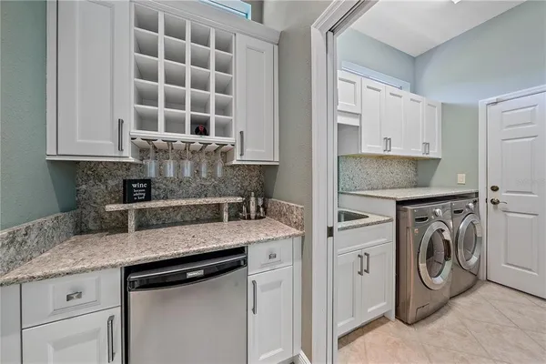 a kitchen with stainless steel appliances granite countertop a sink and a stove