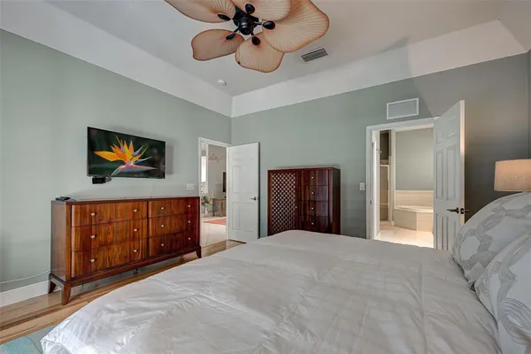 a bedroom with a bed and a chandelier