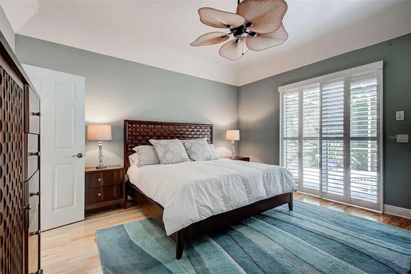 a bedroom with a large bed and a chandelier