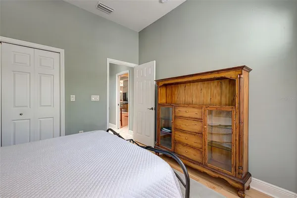 a bedroom with a bed and a dresser