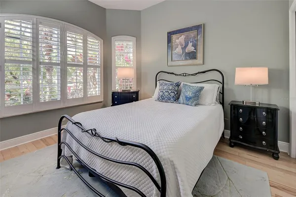 a bed sitting in a bedroom next to a window
