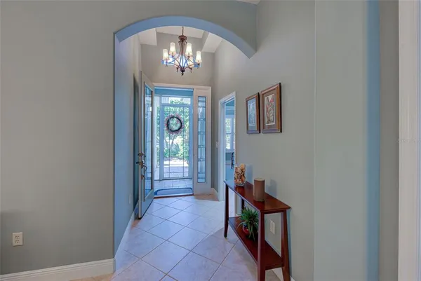 a view of a hallway with a chandelier