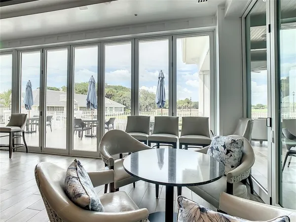 a balcony with furniture and a floor to ceiling window