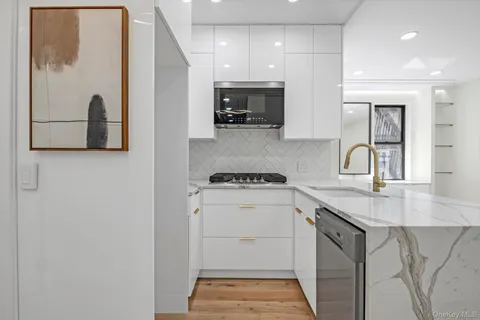 a kitchen with a sink a stove and cabinets