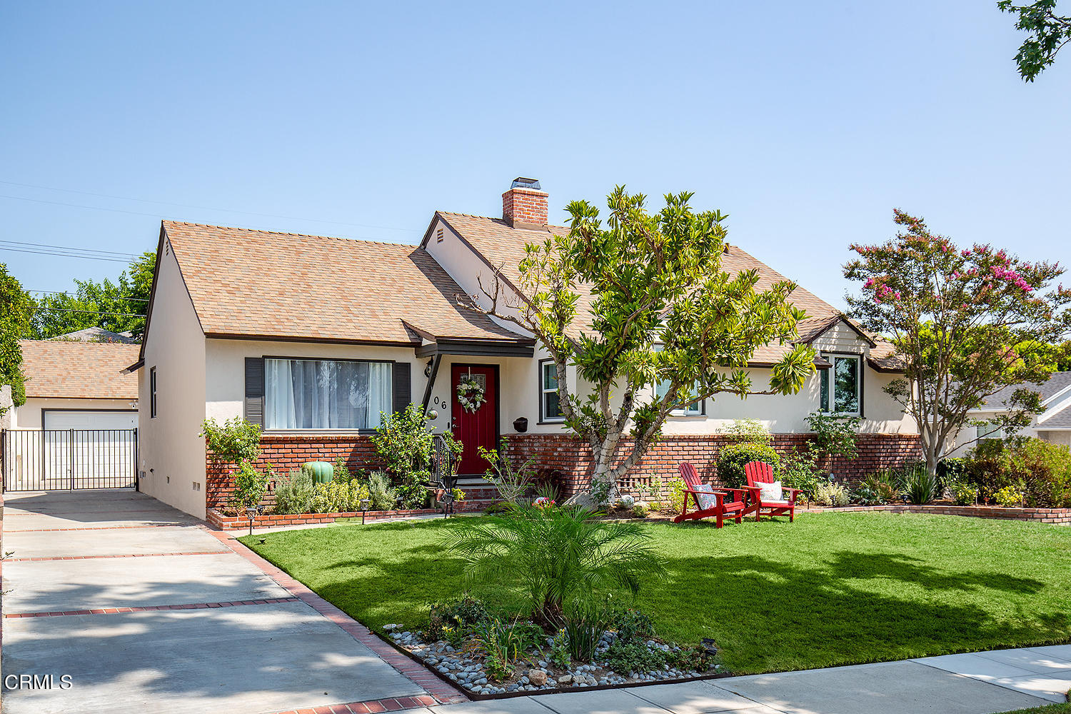 a front view of house with a garden