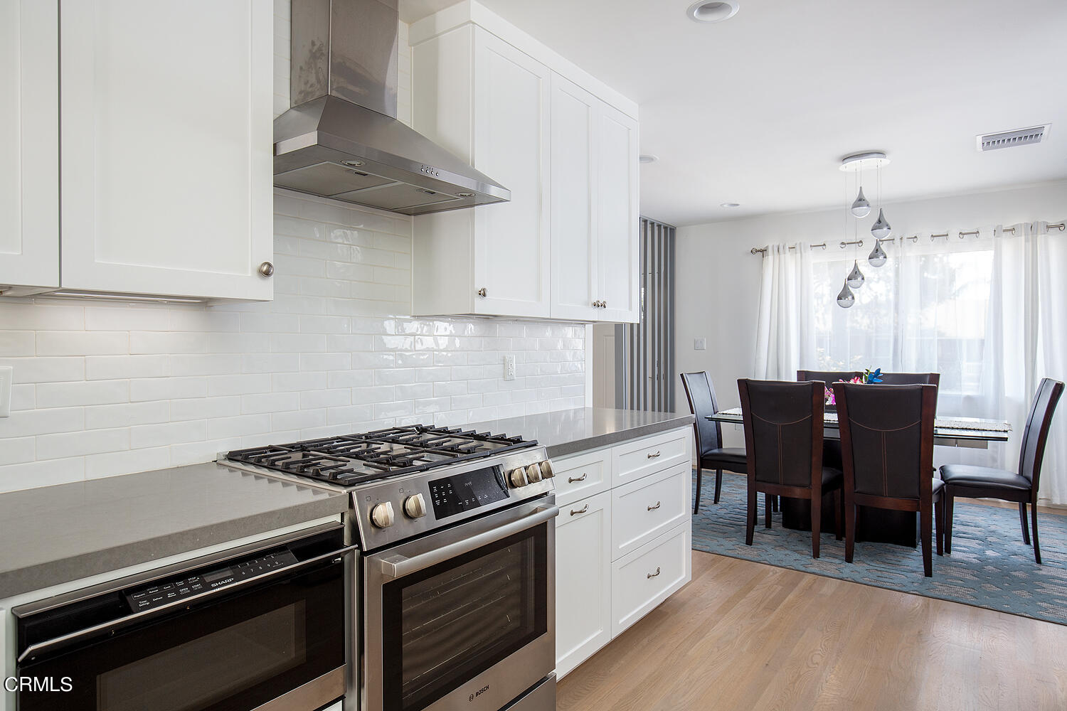 706 Tufts Avenue Burbank, CA 91504 - Photo 16 of 30 a kitchen with stainless steel appliances a white table and chairs