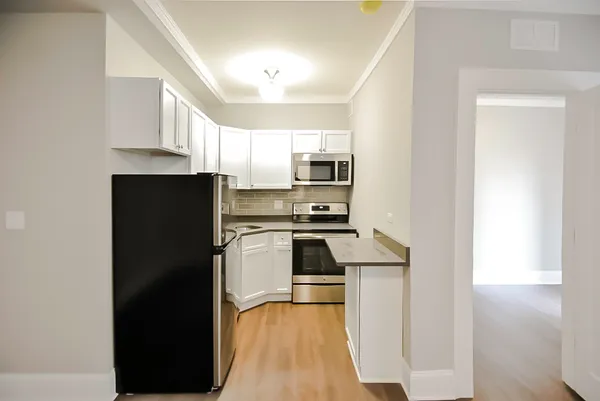 a kitchen with kitchen island a counter top space a sink and appliances