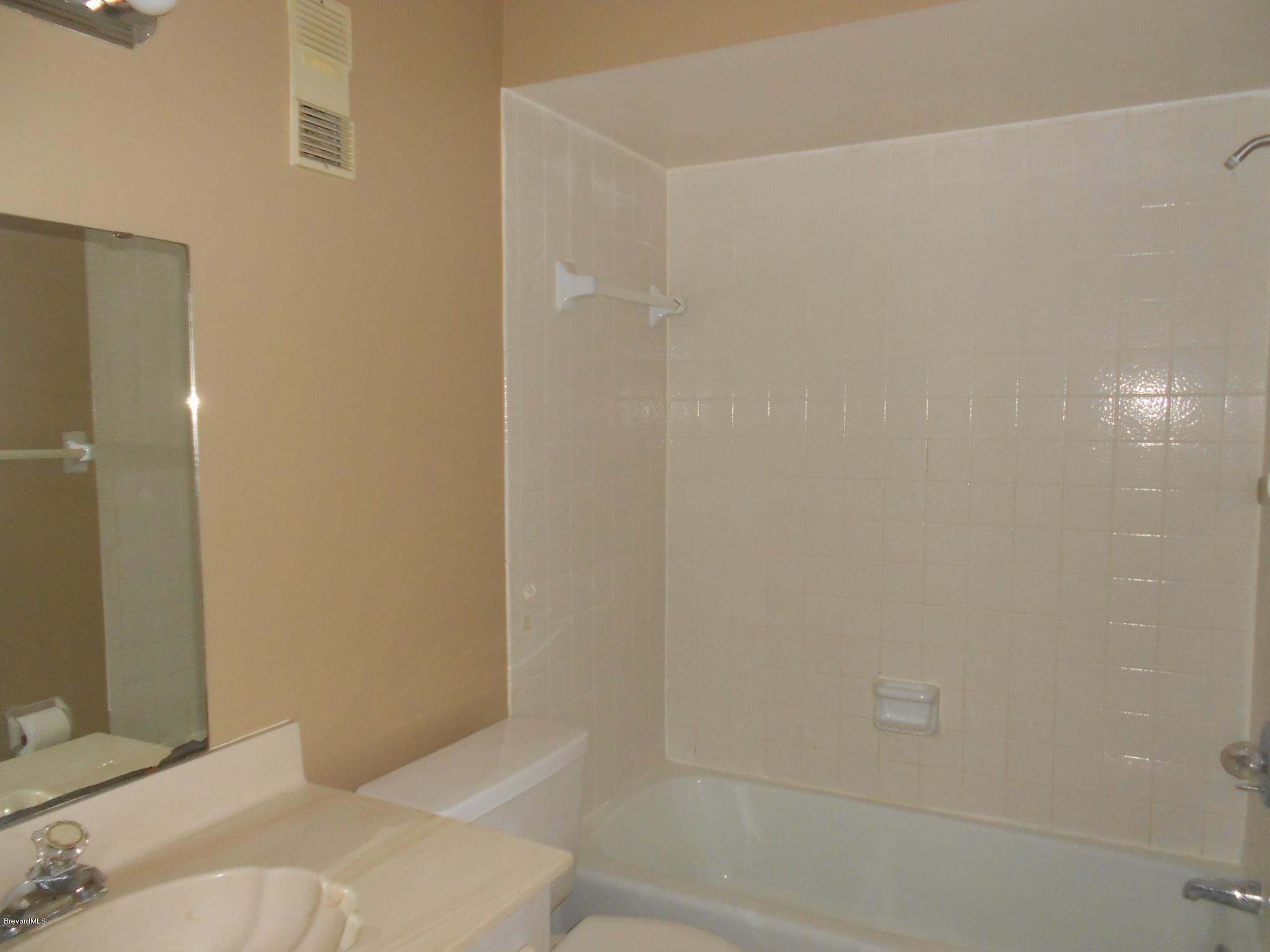 400 Catalina Road, Unit 203 Cocoa Beach, FL 32931 - Photo 6 of 10 a bathroom with a bathtub and shower