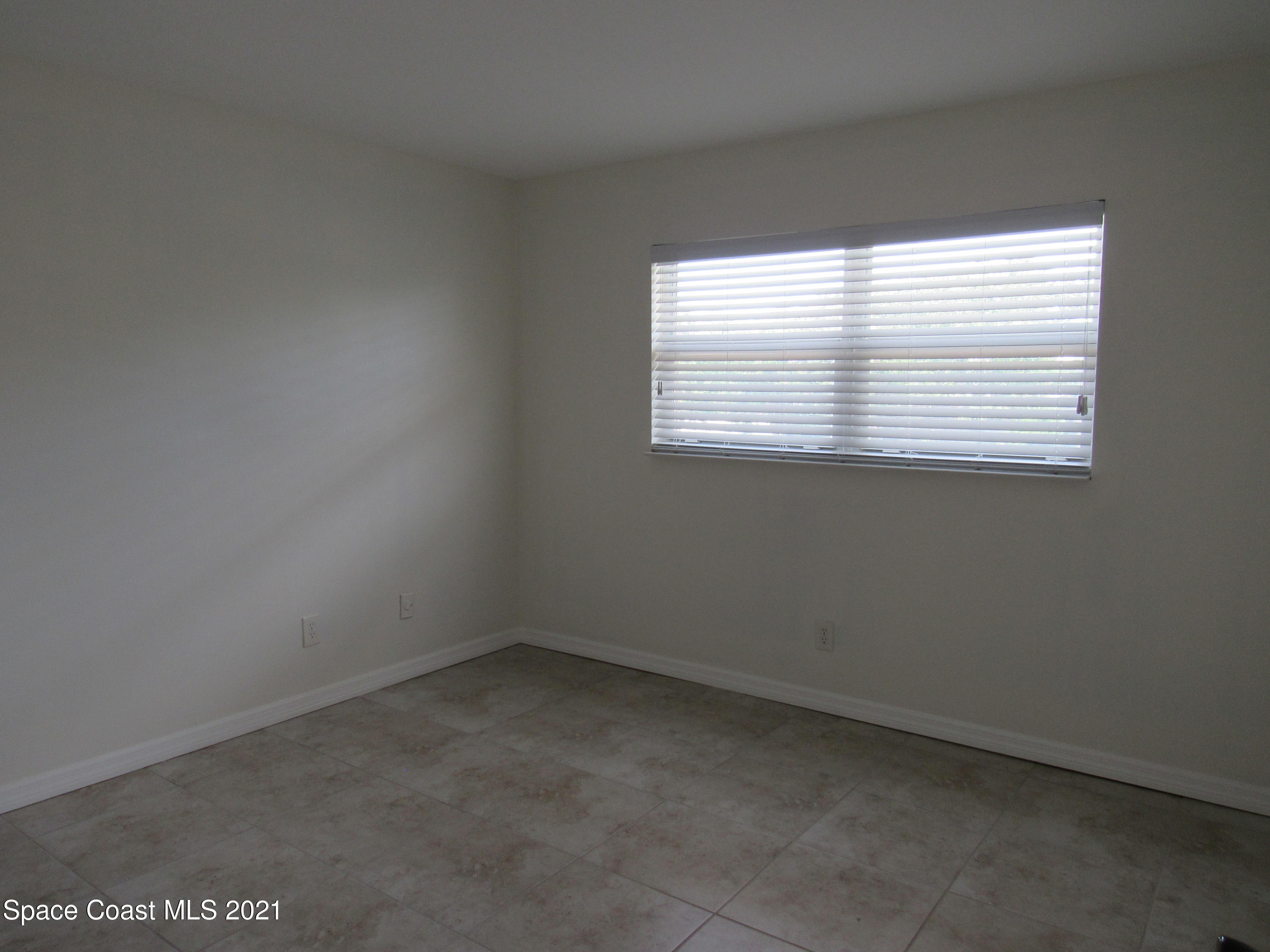 400 Catalina Road, Unit 203 Cocoa Beach, FL 32931 - Photo 7 of 10 an empty room with a window