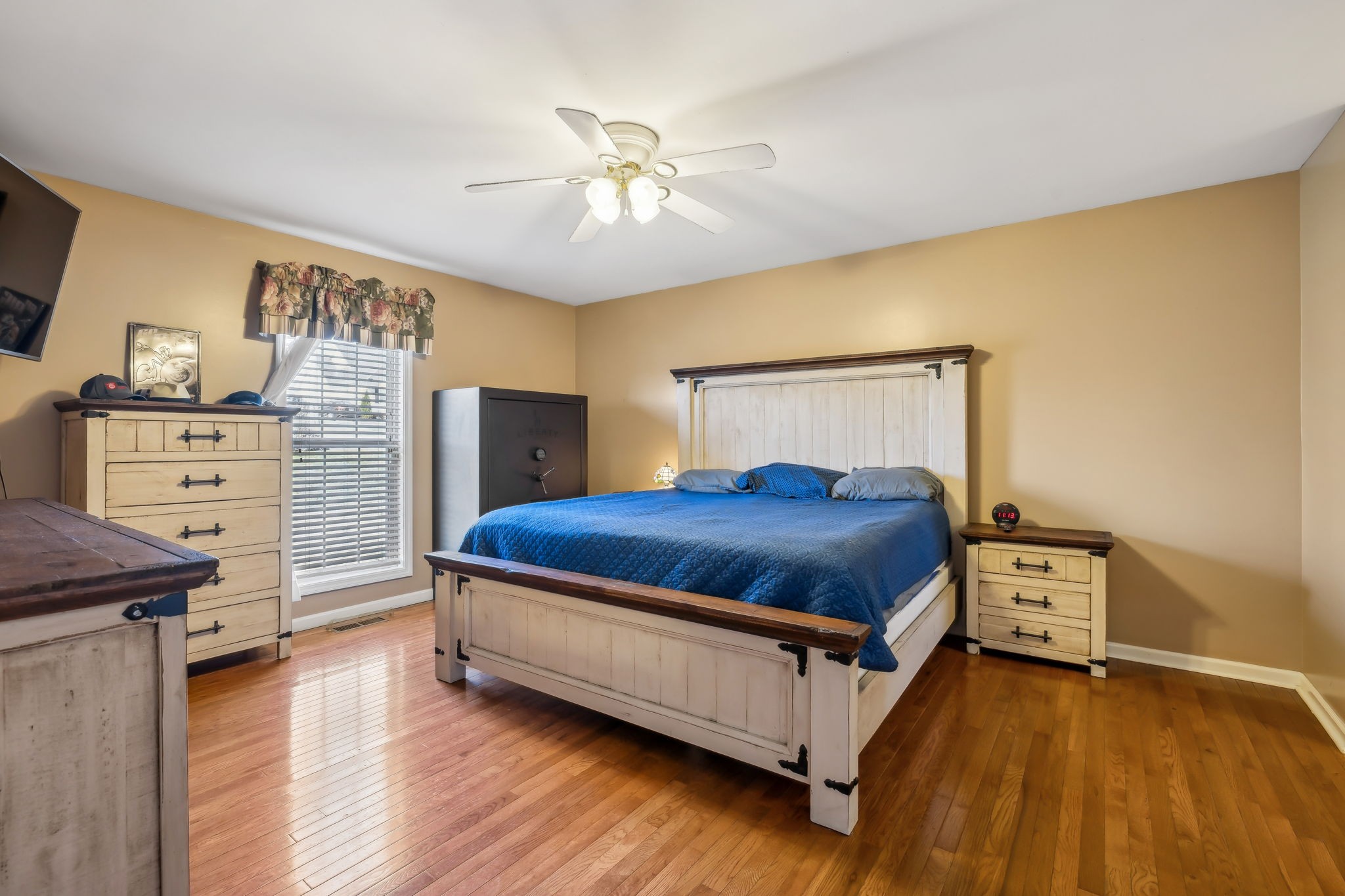 819 Blakemore Road Dickson, TN 37055 - Photo 24 of 54 a spacious bedroom with a bed and wooden floor