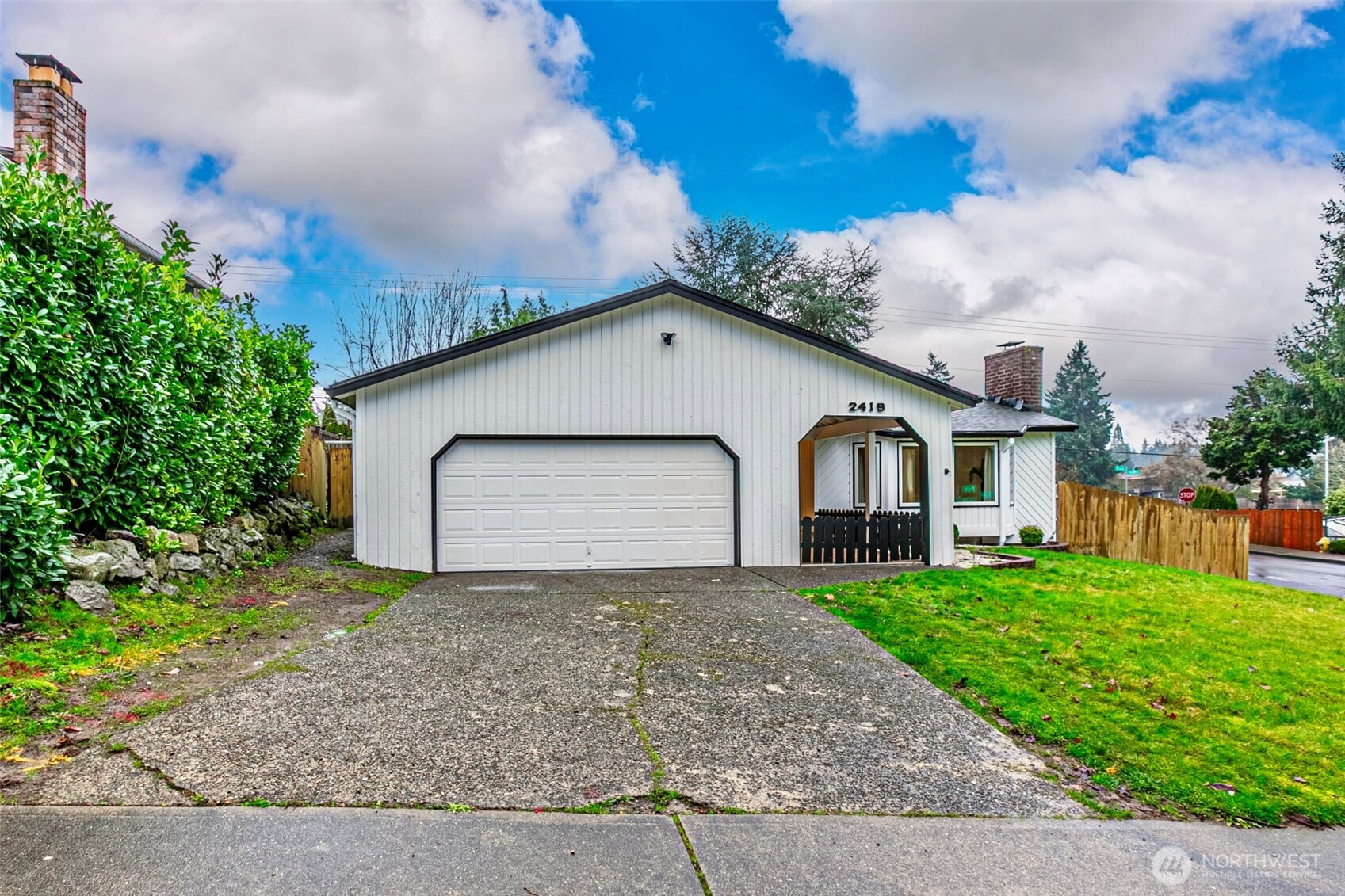 2419 Southwest 319th Place Federal Way, WA 98023 - Photo 39 of 40 a front view of a house with a yard and garage