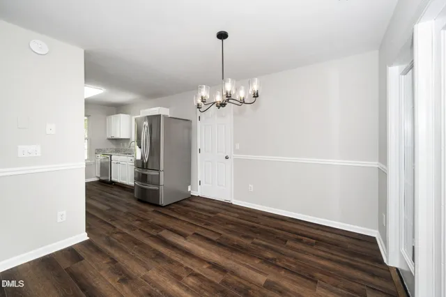 a view of a kitchen with wooden floor and a window